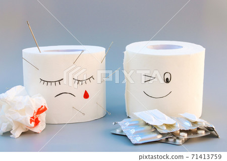Toilet paper and pills. Concept of hemorrhoid treatment. 71413759