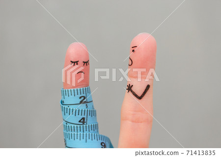 Fingers art of couple with meter. Concept husband is angry that his wife can not lose weight. Fingers art of couple with meter. Concept husband is angry that his wife can not lose weight. 71413835