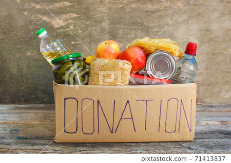 Donation box with food on old wooden background Donation box with food on old wooden background 71413837