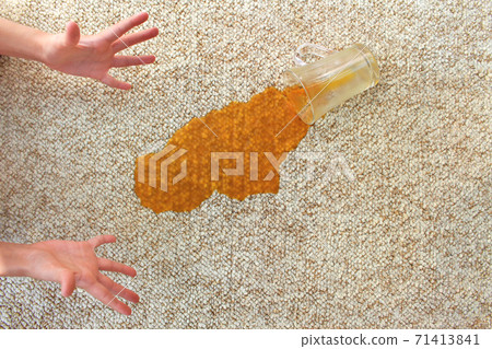 Glass of juice fell on carpet. Drink spilled on floor. Glass of juice fell on carpet. Drink spilled on floor. 71413841