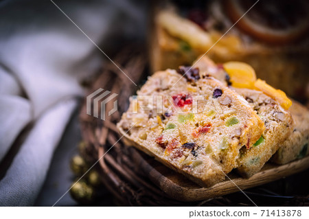 Fresh sliced homemade fruit cake with juicy candied fruits Fresh sliced homemade fruit cake with juicy candied fruits 71413878