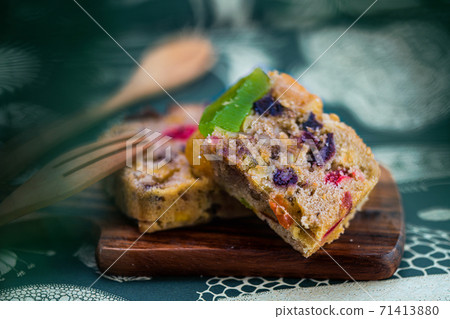 Fresh sliced homemade fruit cake with juicy candied fruits Fresh sliced homemade fruit cake with juicy candied fruits 71413880