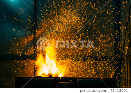 Flame and fire spark with bokeh from burning charcoal on dark abstract background Flame and fire spark with bokeh from burning charcoal on dark abstract background 71413901