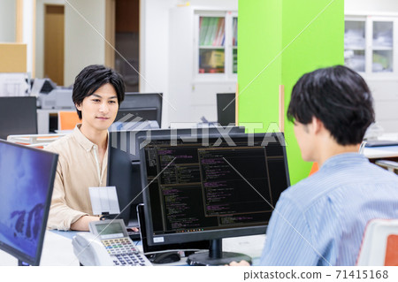 A businessman doing desk work in a casual office A businessman doing desk work in a casual office 71415168