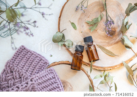 Two wood and two aroma oil bottles. Image of home time, organic and beauty. Two wood and two aroma oil bottles. Image of home time, organic and beauty. 71416052