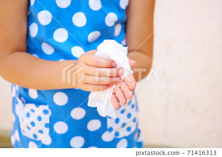 Child wipes his hands with damp cloth. Child wipes his hands with damp cloth. 71416313