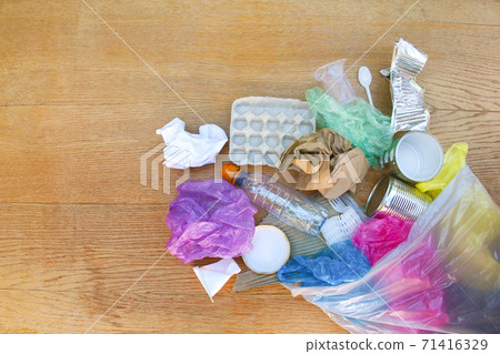 Garbage bag with different trash on wooden background. Flat lay. Garbage bag with different trash on wooden background. Flat lay. 71416329