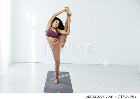 Beautiful woman brunette yoga gymnastics flexible stretching asana Beautiful woman brunette yoga gymnastics flexible stretching asana 71416462