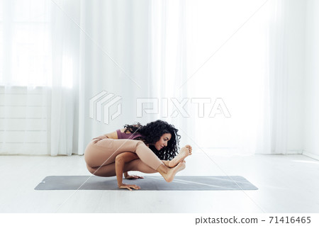 Beautiful woman brunette yoga gymnastics flexible stretching asana Beautiful woman brunette yoga gymnastics flexible stretching asana 71416465