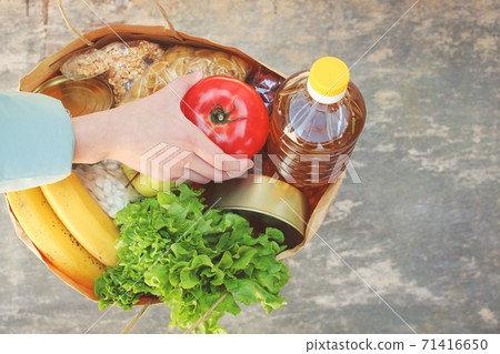 Cardboard bag with products. Concept of people engaged in charity. Cardboard bag with products. Concept of people engaged in charity. 71416650