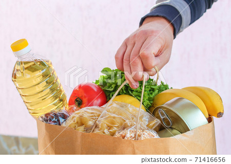 Cardboard bag with products. Concept of man engaged in charity. Cardboard bag with products. Concept of man engaged in charity. 71416656