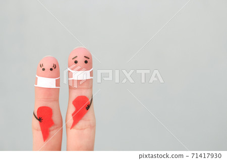 Fingers art of couple in medical mask from COVID-2019. Concept of couple holding broken heart. 71417930