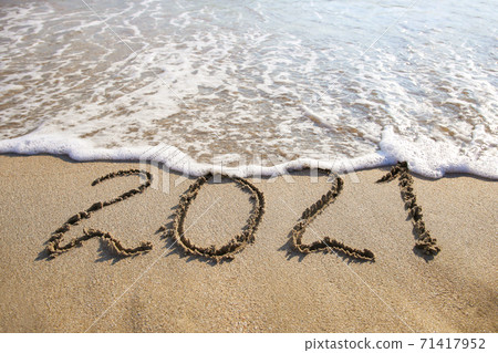 2021 year written on sandy beach sea. Top view. Flat lay. 71417952