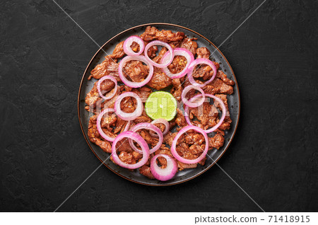 Bistek Tagalog or Bistec Encebollado on black plate on slate table top. Filipino  cuisine beef steak 71418915