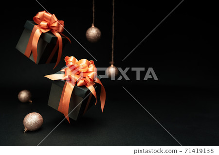 Falling gift boxes with orange ribbon, balls with copy space. Xmas present, Christmas banner Falling gift boxes with orange ribbon, balls with copy space. Xmas present, Christmas banner 71419138