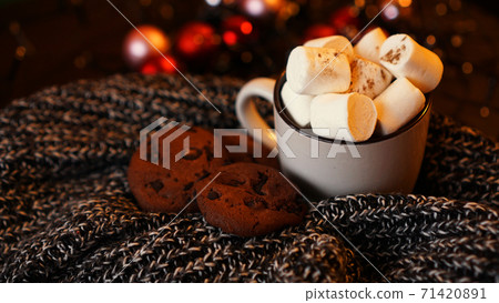 Mug with marshmallows and chocolate chip cookies on dark Christmas background Mug with marshmallows and chocolate chip cookies on dark Christmas background 71420891