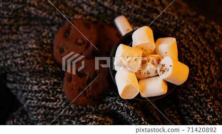 Mug with marshmallows and chocolate chip cookies on dark Christmas background Mug with marshmallows and chocolate chip cookies on dark Christmas background 71420892
