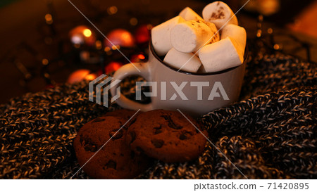 Mug with marshmallows and chocolate chip cookies on dark Christmas background Mug with marshmallows and chocolate chip cookies on dark Christmas background 71420895