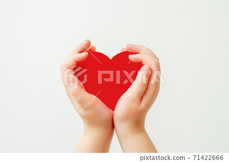Paper red heart in child's hands. 71422666