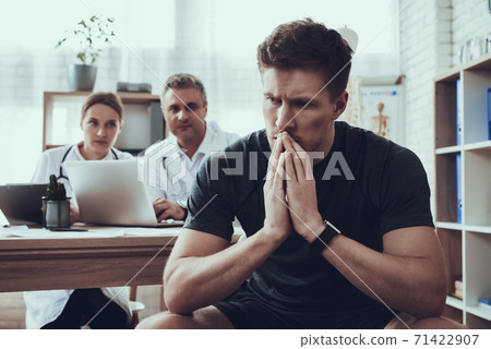 The patient sits at the doctor office in office. The patient sits at the doctor office in office. 71422907