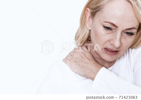 A woman has a sore neck. 71423063