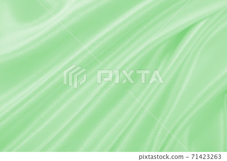 Smooth elegant green silk or satin luxury cloth texture as abstract background. Luxurious background design 71423263