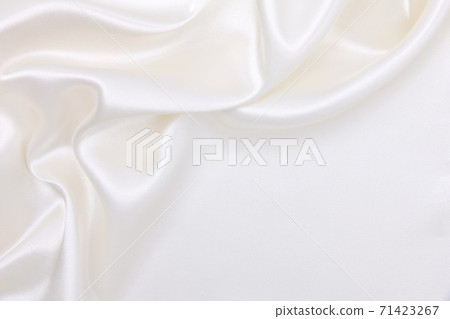 Smooth elegant white silk or satin luxury cloth texture as wedding background. Luxurious background design Smooth elegant white silk or satin luxury cloth texture as wedding background. Luxurious background design 71423267