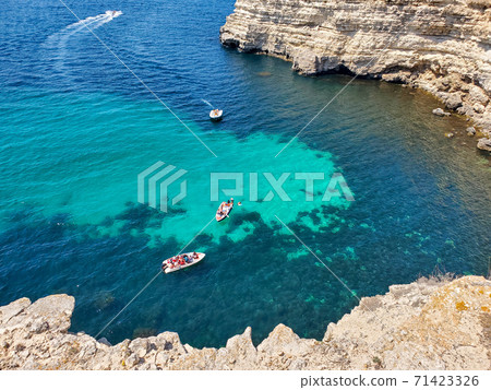 Motor boats at sea on a Sunny summer day. Water trips on the sea on motor boats. Vacation at the sea Motor boats at sea on a Sunny summer day. Water trips on the sea on motor boats. Vacation at the sea 71423326