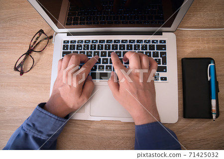 Men's hands using a laptop Men's hands using a laptop 71425032