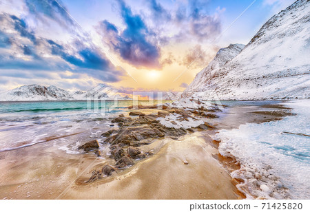 Fantastic winter view of  Haukland beach during sunset with lots of snow  and snowy  mountain peaks 71425820