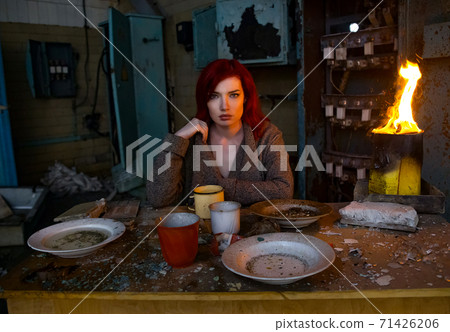 Girl in the factory in a coat  71426206