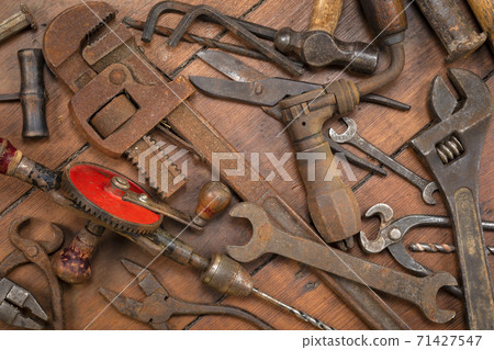 Vintage tools on a wooden background Vintage tools on a wooden background 71427547