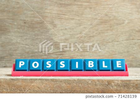Tile letter on red rack in word possible on wood background Tile letter on red rack in word possible on wood background 71428139