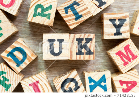Alphabet letter block in word UK (abbreviation of united kingdom) with another on wood background Alphabet letter block in word UK (abbreviation of united kingdom) with another on wood background 71428153