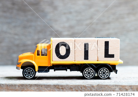 Truck hold letter block in word oil on wood background 71428174