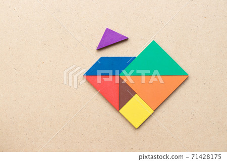 Color tangram puzzle wait for fulfill to heart shape on wood table 71428175