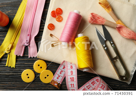 Sewing supplies on wooden background, top view 71430391