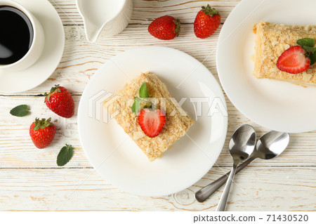 Concept of lunch with Napoleon cake on white wooden background 71430520