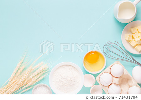 Ingredients for baking on light blue background. Ingredients for baking on light blue background. 71431794