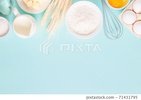 Ingredients for baking on light blue background. Ingredients for baking on light blue background. 71431795