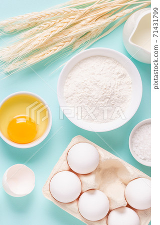 Ingredients for baking on light blue background. Ingredients for baking on light blue background. 71431799