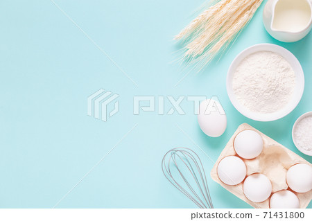 Ingredients for baking on light blue background. 71431800