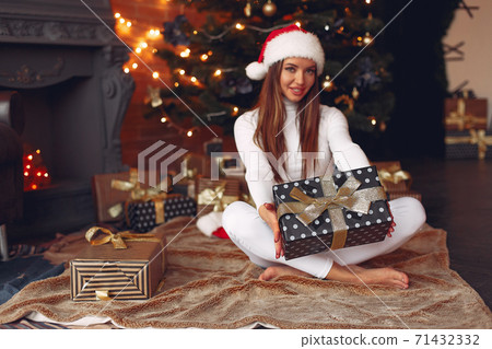 Beautiful girl at home near christmas tree Beautiful girl at home near christmas tree 71432332