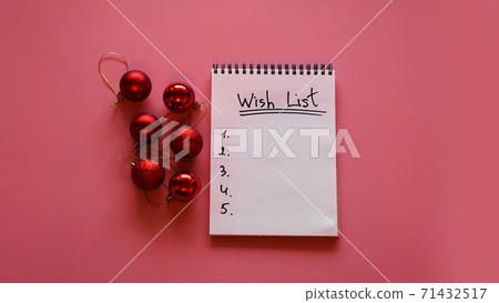 Notebook on pink background with christmas balls 71432517
