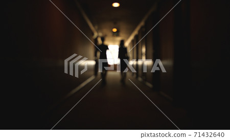 Back view of Caucasian young couple walking hotel hallway Back view of Caucasian young couple walking hotel hallway 71432640