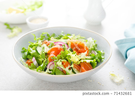 Salmon avocado salad with salted fish, lettuce, red onion and cucumbers 71432681
