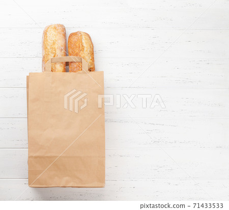 French baguette bread in paper bag French baguette bread in paper bag 71433533