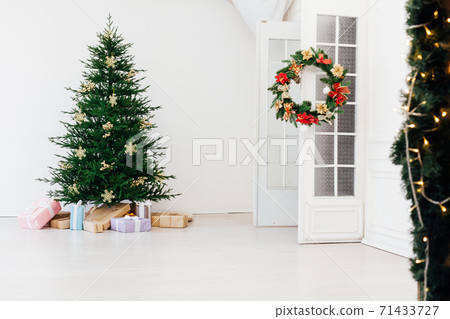 Christmas tree pine with gifts for the new year interior of the white room Christmas tree pine with gifts for the new year interior of the white room 71433727