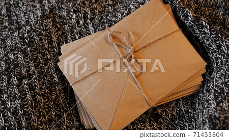 Bundle of letters tied with string on a knitted background 71433804