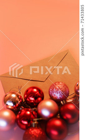 Envelope from craft paper with christmas red and pink balls on pink background Envelope from craft paper with christmas red and pink balls on pink background 71433805